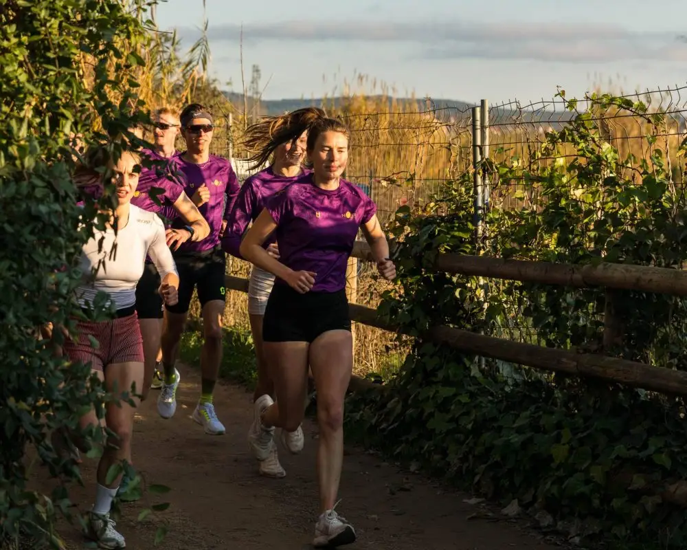 Custom running jersey with team logo and purple design from the PTC team – TD Sportswear